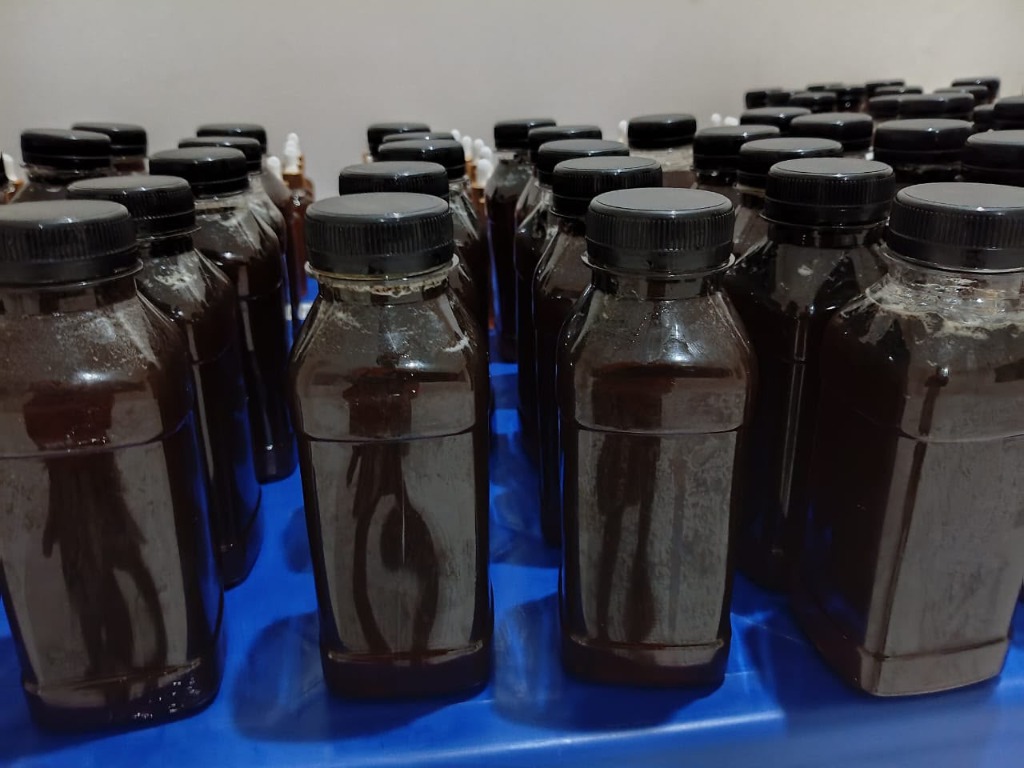 Close-up of sealed honey and propolis bottles